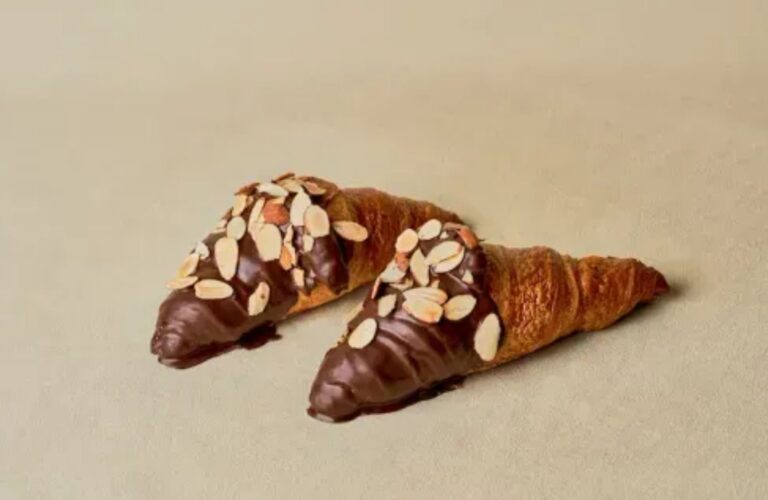 Best Korean Desserts to Try in Iowa : Chocolate almond croissants with sliced almonds and rich chocolate glaze at Tous Les Jours Iowa – best Korean desserts in Iowa.