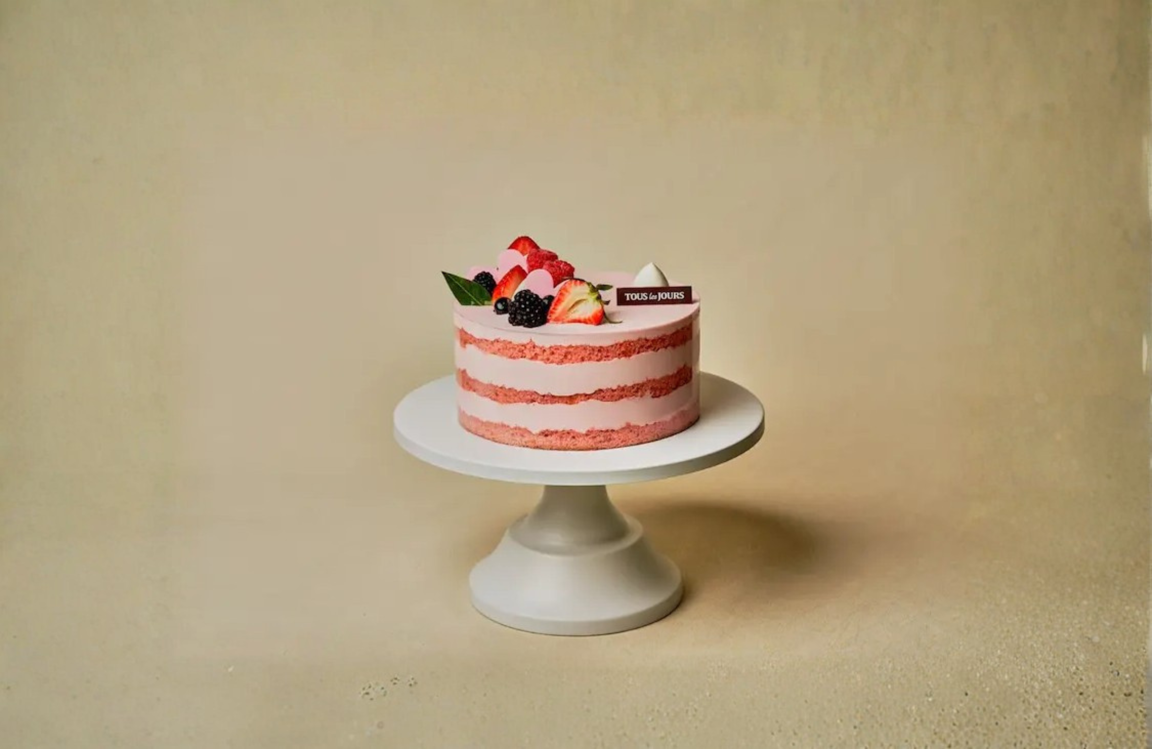 Fourth of July Strawberry Layer Cake Strawberry layer cake with fresh berries and cream, ideal for Fourth of July parties and family gatherings in West Des Moines