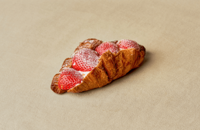 Best July 4th Desserts in West Des Moines: Cakes, Pastries & Sweet Treats for Your Celebration – A flaky butter croissant filled with fresh strawberries, whipped cream, and a light dusting of powdered sugar, making it a delicious Fourth of July dessert and festive sweet treat in West Des Moines.
